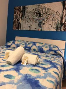 a bed with two pillows on top of it at Case Saniela in Terrasini