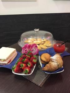 a table with two plates of food with strawberries and pastries at B&B Ippocastano in Casarano +9 photos