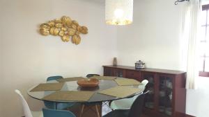 a dining room table with chairs and a bowl on it at Parque Campismo Porto Côvo in Porto Covo