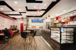 a restaurant with people sitting at tables and a counter at Viktoria Central Apartment in Budapest