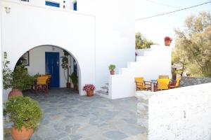 a white house with a blue door and a patio at Panorama in Amorgos +17 photos