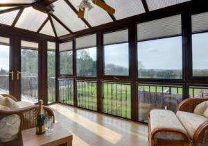 a large living room with large windows and a couch at High View Retreat in Lewes