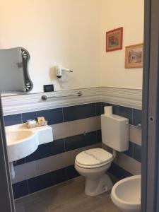 a bathroom with a toilet and a sink at Hotel Marinella in Celle Ligure