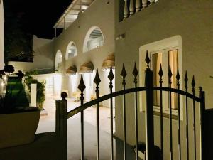 a fence in front of a house at night at Sailor's Nautical Concept in Spetses