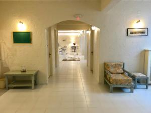 a hallway with two chairs and a table in a building at Sailor's Nautical Concept in Spetses