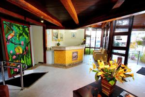 a living room with a painting on the wall at Hotel Adriattico in Porto Seguro