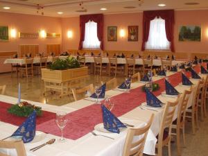 a banquet hall with tables and chairs with blue napkins on them at Motel Divjak in Spodnje Hoče