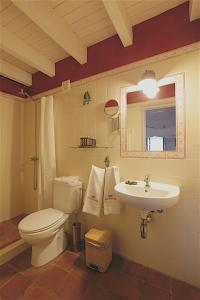 a bathroom with a toilet and a sink at Monte da Xica - Somente Adultos in Zambujeira do Mar