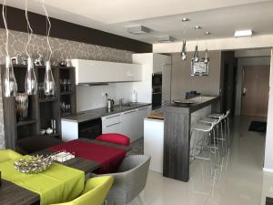 a kitchen and living room with a table and chairs at Panorama Donovaly 34-B in Donovaly