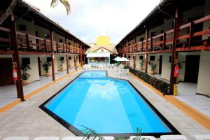 a swimming pool in the middle of a building at Hotel Adriattico in Porto Seguro