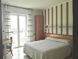 a bedroom with a bed and a sliding glass door at Alessio Camere in Bardolino +40 photos