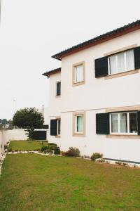 a house with a green yard in front of it at Casa Rural in Esposende +9 photos