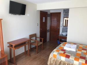 Postel nebo postele na pokoji v ubytování Sumaq Hotel Tacna
