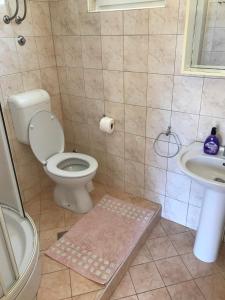 a bathroom with a toilet and a sink at Summer rooms Baška in Baška +40 photos