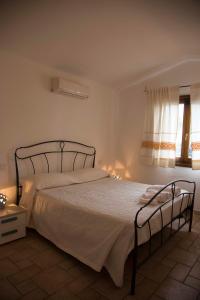 a bedroom with a bed in a room with a window at Bados Mare in Olbia