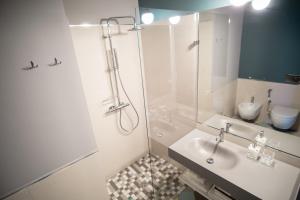 a white bathroom with a shower and a sink at B&B Villa Sant'Angelo in Ginosa Marina