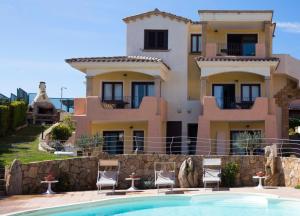 a villa with a swimming pool in front of a house at Bados Mare in Olbia