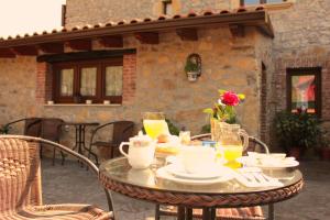 a table with plates and drinks on a patio at Posada Fernanda in Pomar