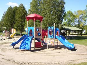 a playground with a slide in a park at Square Rigger Lodge in Jacksonport