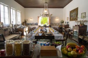 a large dining room with a long table with food at Quinta da Alcaidaria Mor in Ourém +49 photos