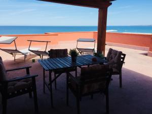 a table and chairs on a patio with the ocean at Attico Giusy in Balestrate