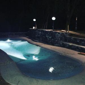 a swimming pool at night with blue water at Cottage in front of the sea in Bonassola