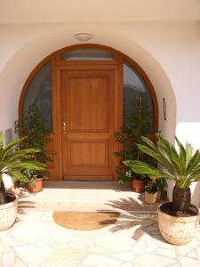 a wooden door with potted plants in front of it at Villa Maja in Baška