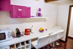 a kitchen with a table with chairs and a microwave at Domus Paradiso City Center in Rome