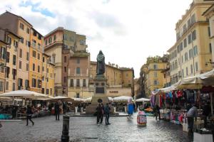 a group of people walking around a street with a statue at Domus Paradiso City Center in Rome