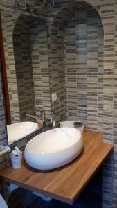 a bathroom with a white sink and a mirror at Apartments Paro in Pag