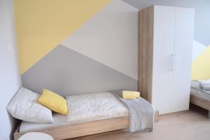 a bedroom with a bed with yellow pillows at Hostel Bratislava in Bratislava