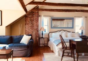 a living room with a bed and a couch at Treadwell Inn in Saint Andrews