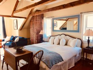a bedroom with a large bed with a mirror on the wall at Treadwell Inn in Saint Andrews