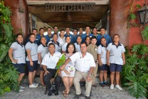 a group of people posing for a picture in front of a building at Hotel Aura del Mar in Zihuatanejo +78 photos