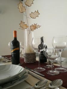 a table with a bottle of wine and wine glasses at Casa Elia in Venice