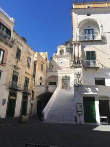a building with a clock on the side of it at Casa Letizia Amalfi Coast in Atrani