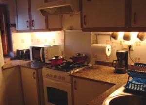 a kitchen with a stove with pots and pans on it at Casa Toblerone in Oliva