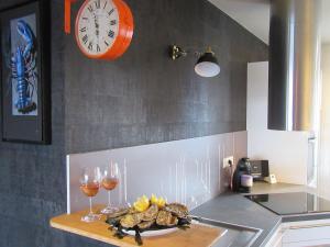 a kitchen with a plate of food and two glasses of wine at ville close in Concarneau +13 photos