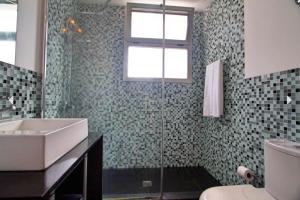 a bathroom with a glass shower and a sink at Villa Cristal in Tijarafe