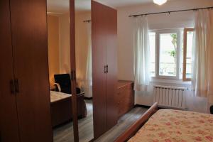 a bedroom with a bed and a dresser and a window at Casa vacanza Luisa in Trieste
