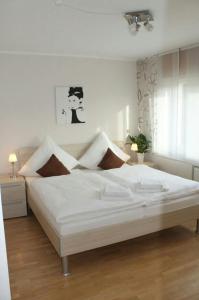 a bedroom with a large white bed in a room at Ferienhaus im Nürburgring in Herschbroich