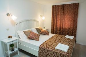 a bedroom with a bed with a red curtain at Apartments Ivica in Split