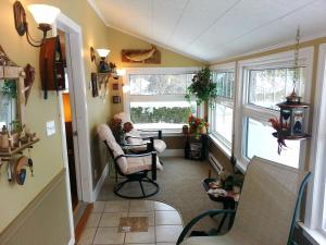 a living room with chairs and a table and windows at 2 bedroom Wiffen Cottage in Port Albert +36 photos