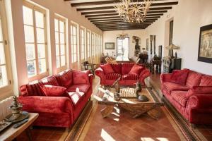 a living room with red couches and a table at El Asiento Del Azar in Banyeres del Penedes