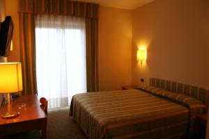 Postel nebo postele na pokoji v ubytování Savant Hotel