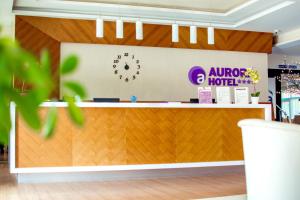 a store counter with a sign on the wall at Hotel Aurora in Miskolctapolca