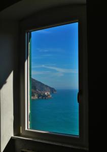 a view of the ocean from a window at La Posada in Corniglia