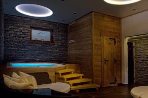 a room with a jacuzzi with a brick wall at Penzión Šafrán in Ždiar +68 photos