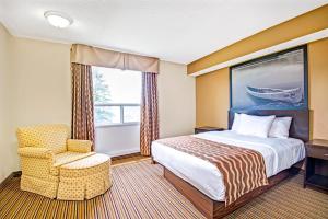 A bed or beds in a room at red maple inn and suites