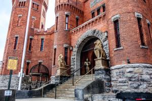 a large red brick building with stairs in front of it at Amsterdam Castle NY in Amsterdam